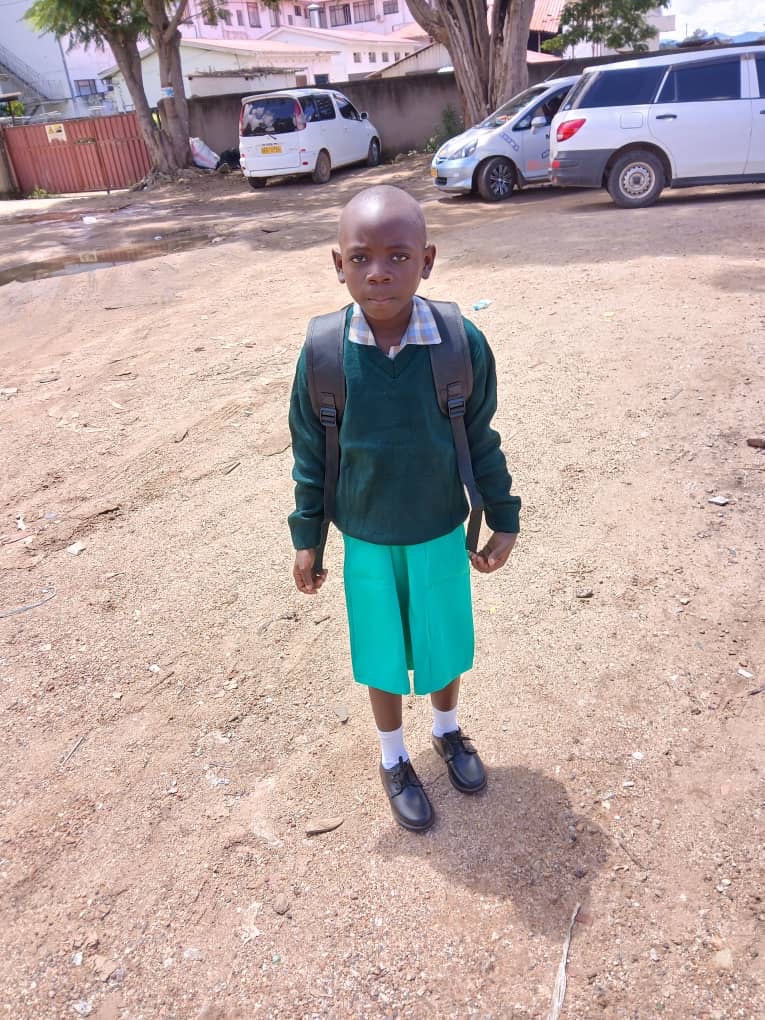 Melody Zuze wearing her school uniform and backpack